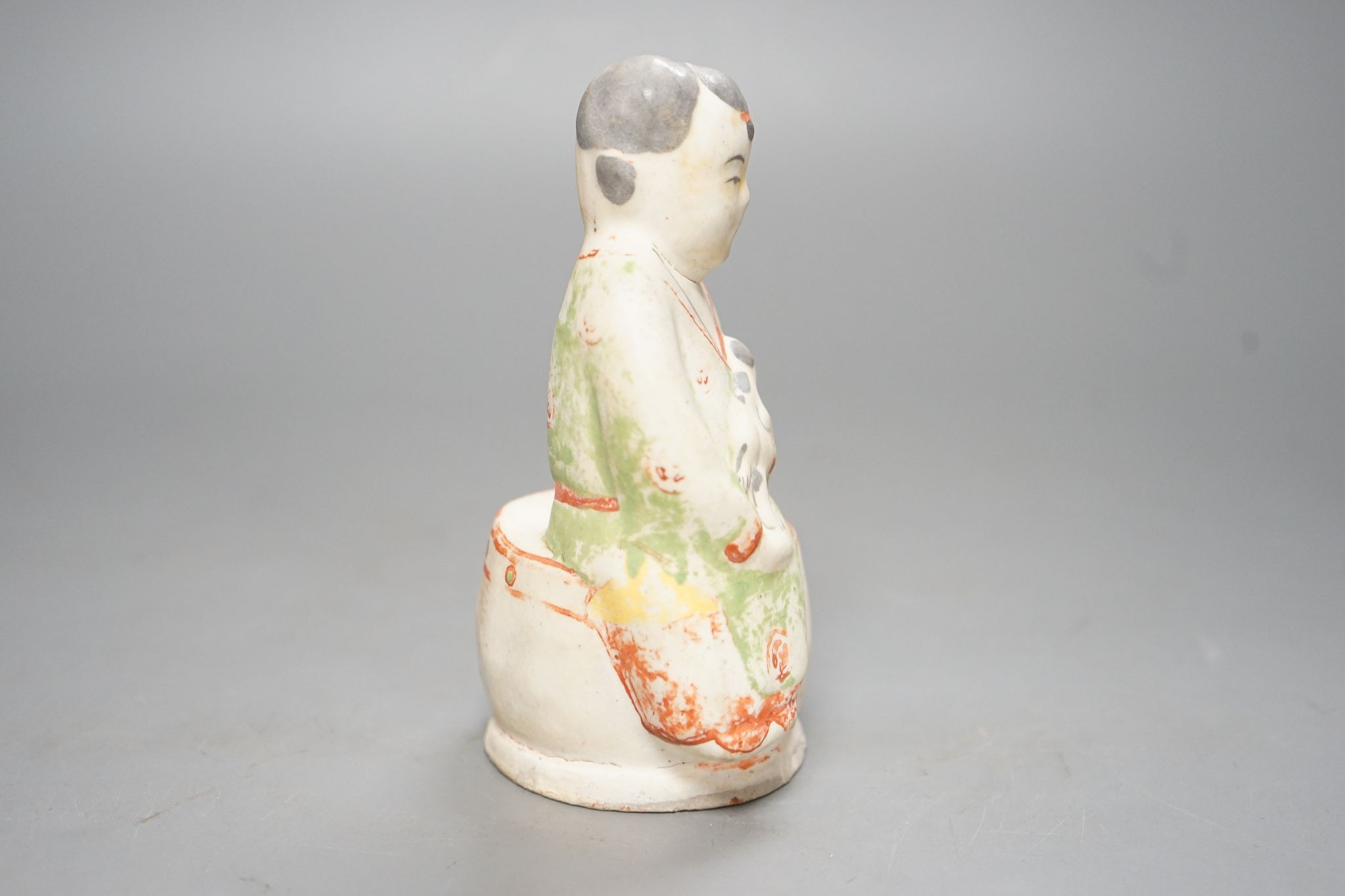 A Chinese Ming cizhou enamelled pottery group of a boy and dog, with case, 14cm